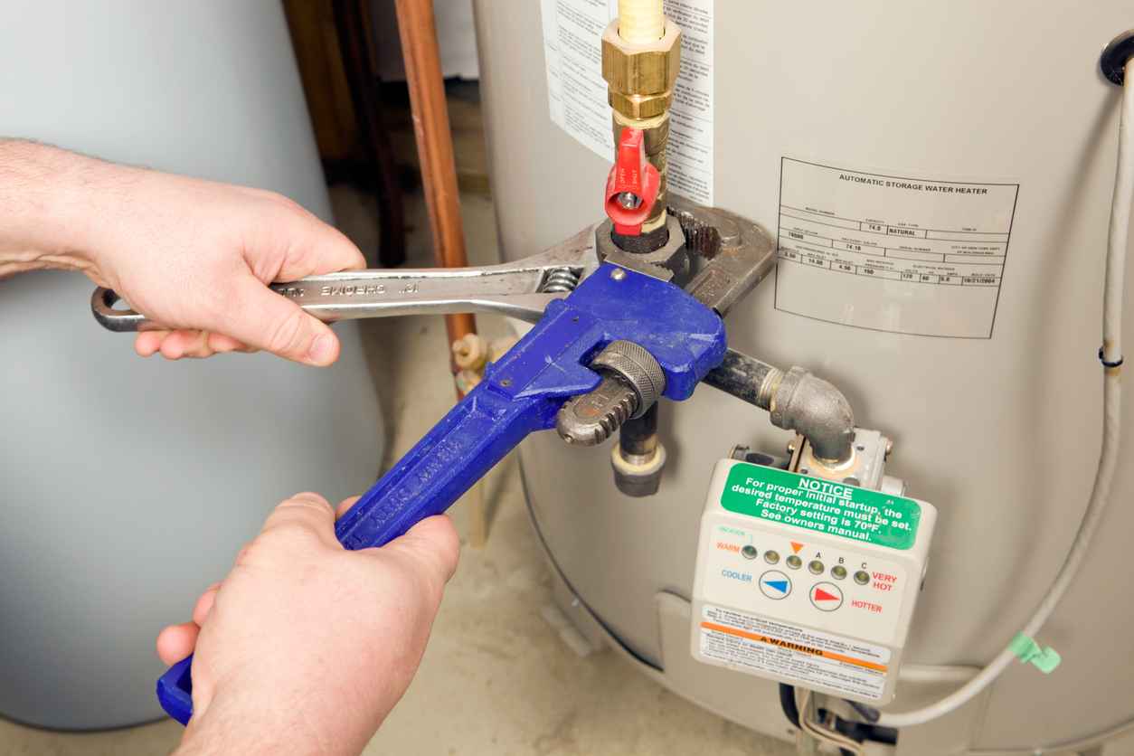 Plumber adjusting a water heater